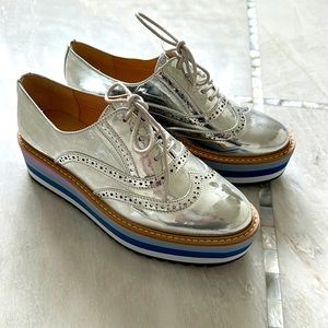 Brand new, never worn. Stunning Aldo lace-up platform silver shoes.